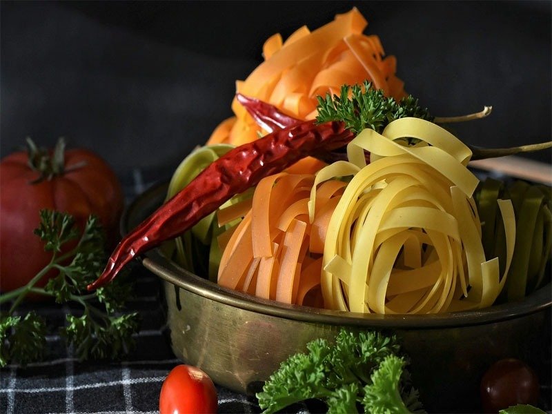 A vibrant plate of colorful Italian pasta showcasing traditional ingredients and rich Mediterranean flavors – a celebration of authentic Italian cuisine.